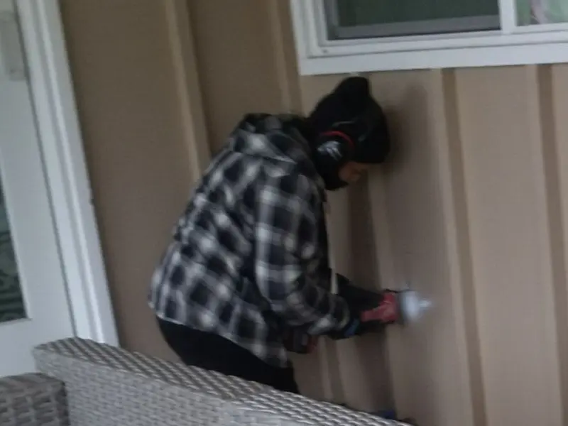 Professional electrician installing an exterior outlet in Orono